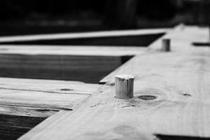 timber framed porch roof bent being assembled