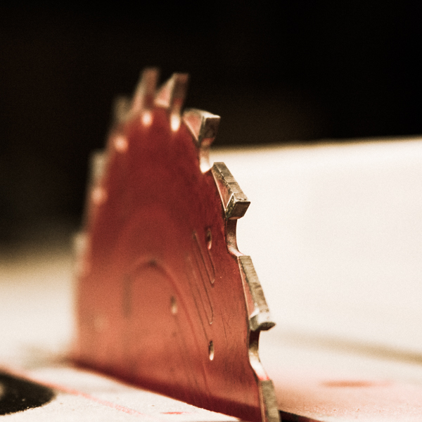 red ripping saw blade on a table saw