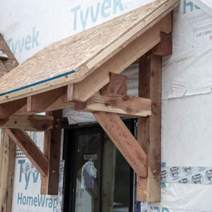 timber framed eyebrow roof over a window