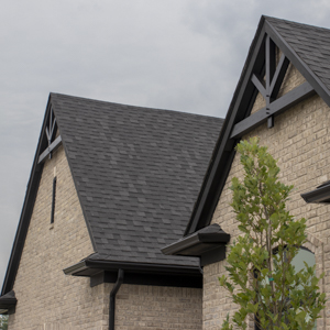 Two timber framed gable trusses on house with double gables