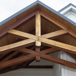 Two cherry timber framed scissor trusses with cedar roof decking above.