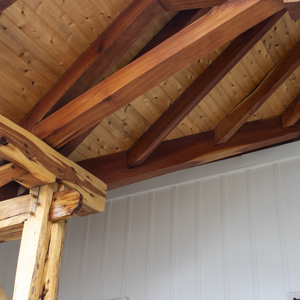 Exposed timber roof framing of a large valley rafter that is supporting the valley jacks.